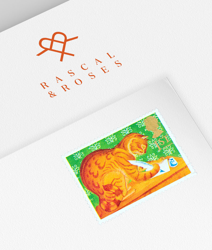 Rascal & Roses orange coloured logo on letterhead and a ginger cat stamp on an envelope